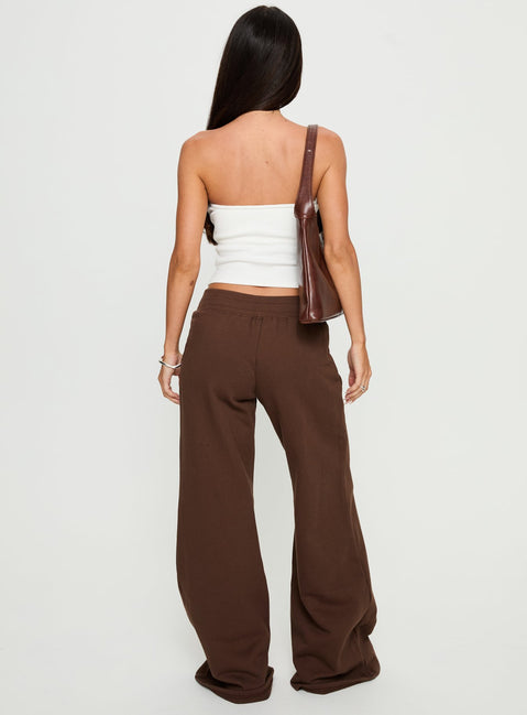 back view of model wearing Princess Polly Summits Flared Track Pants Chocolate High Rise Pants 