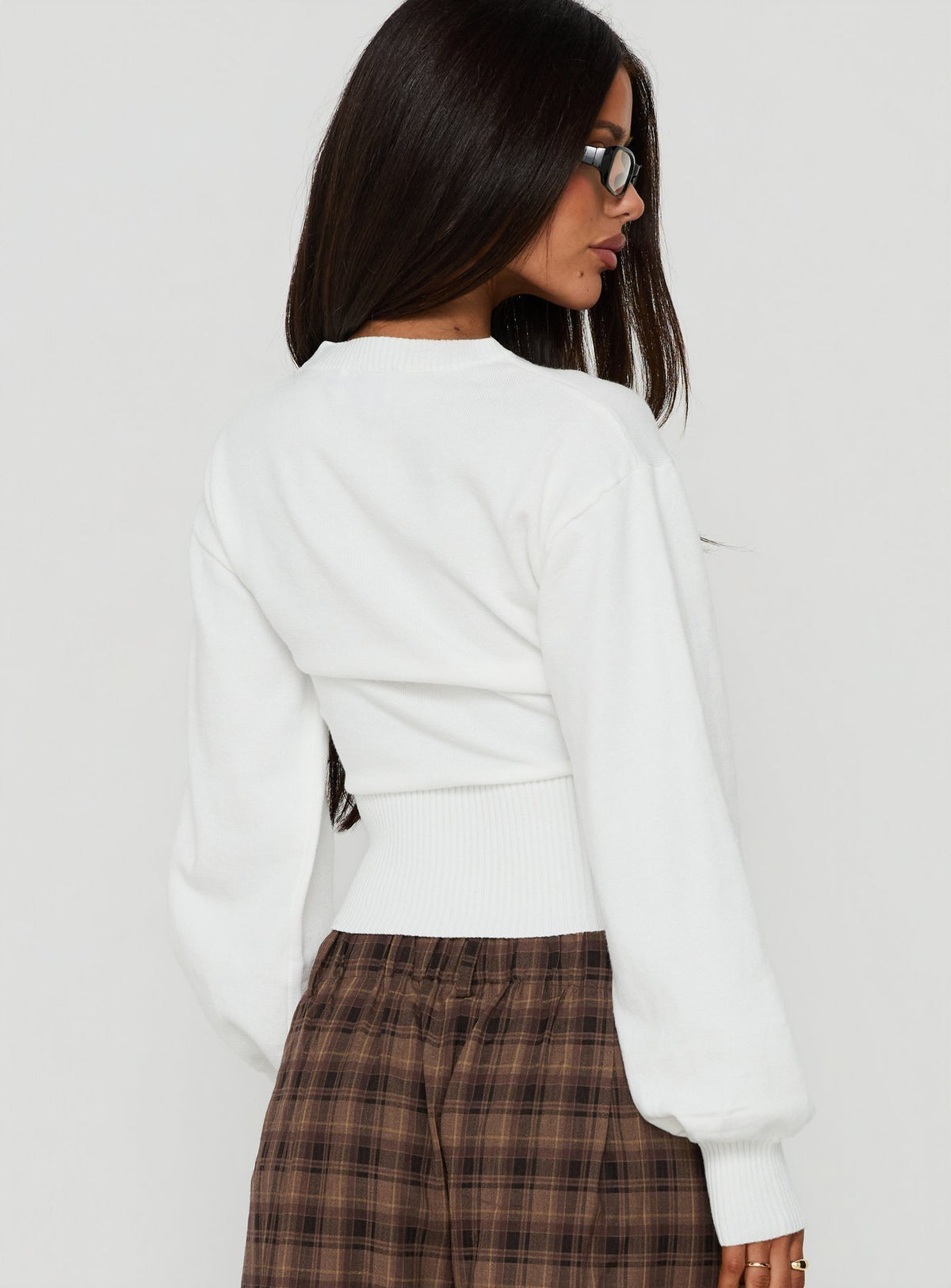 Showcasing the Emerica V Neck Cinched Sweater White womens-jumpers in oversized short length back view of model wearing Princess Polly