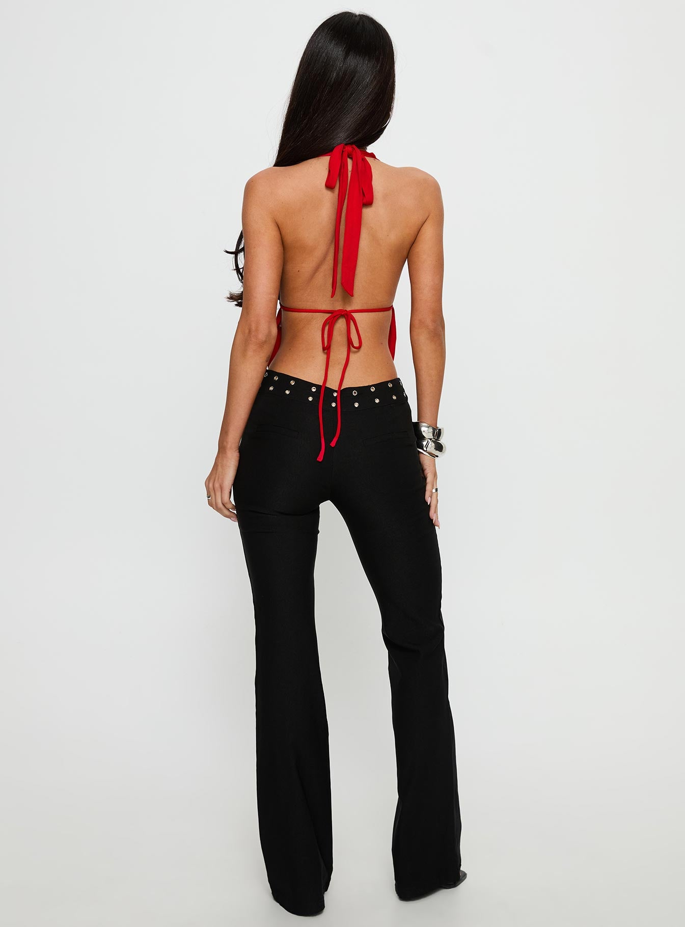 back view of model wearing Princess Polly Yevina Eyelet Flare Pant Black Low Rise Pants 