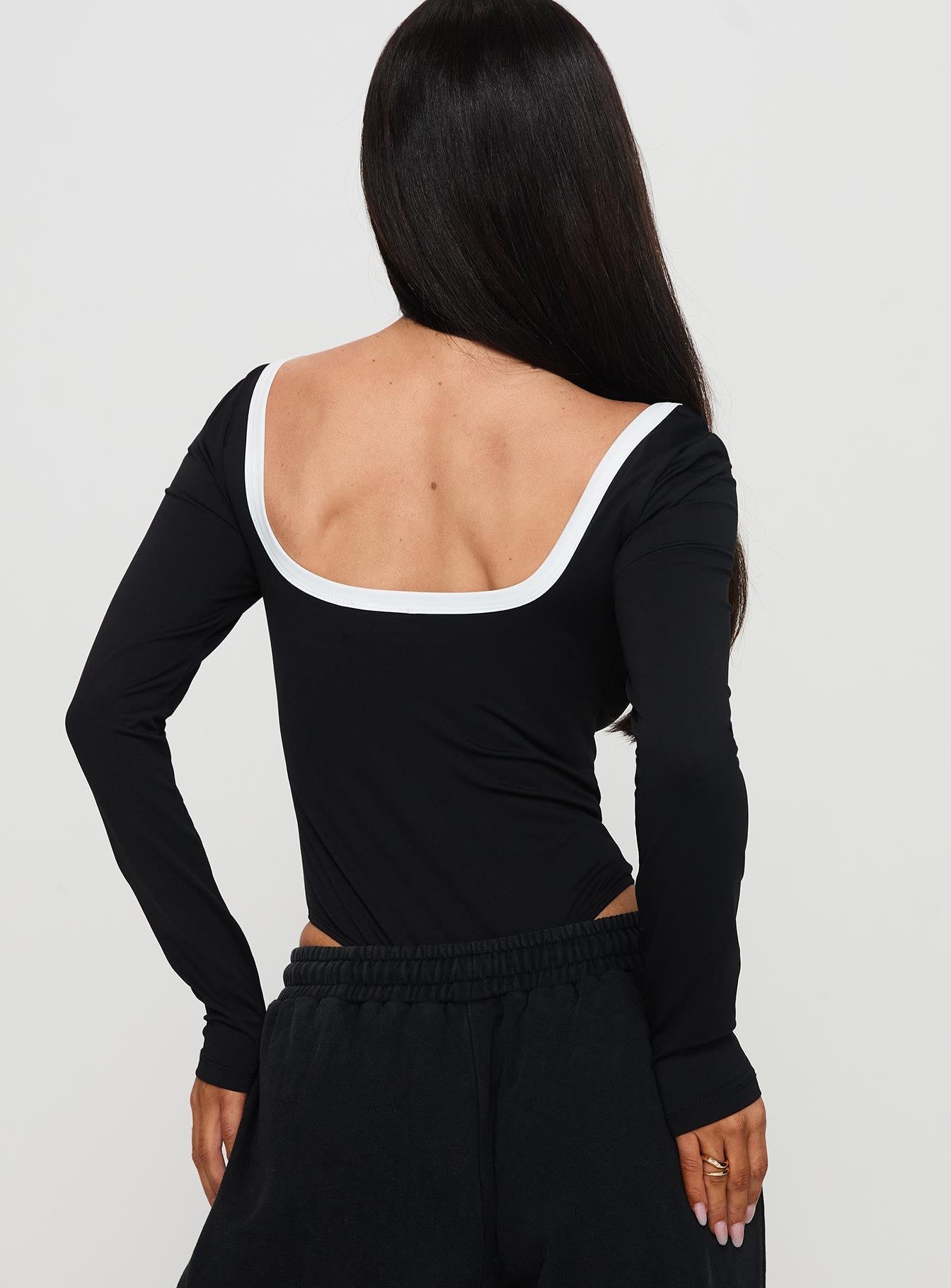 back view of model wearing Princess Polly Ender Contrast Trim Bodysuit Black Long Sleeve Tops 