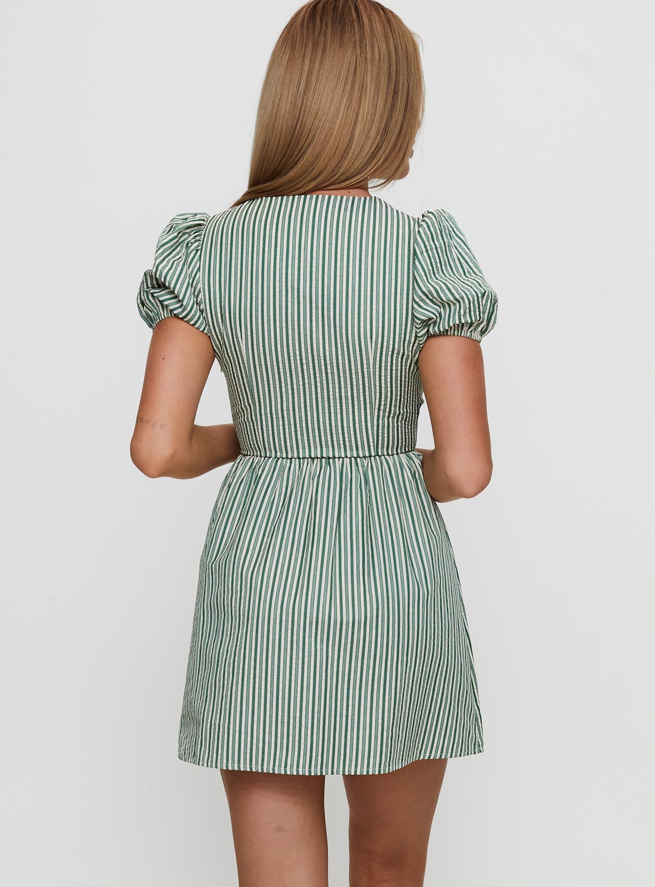 back view of model wearing Princess Polly Nurture Bow Mini Dress Green Stripe Crew Neck 