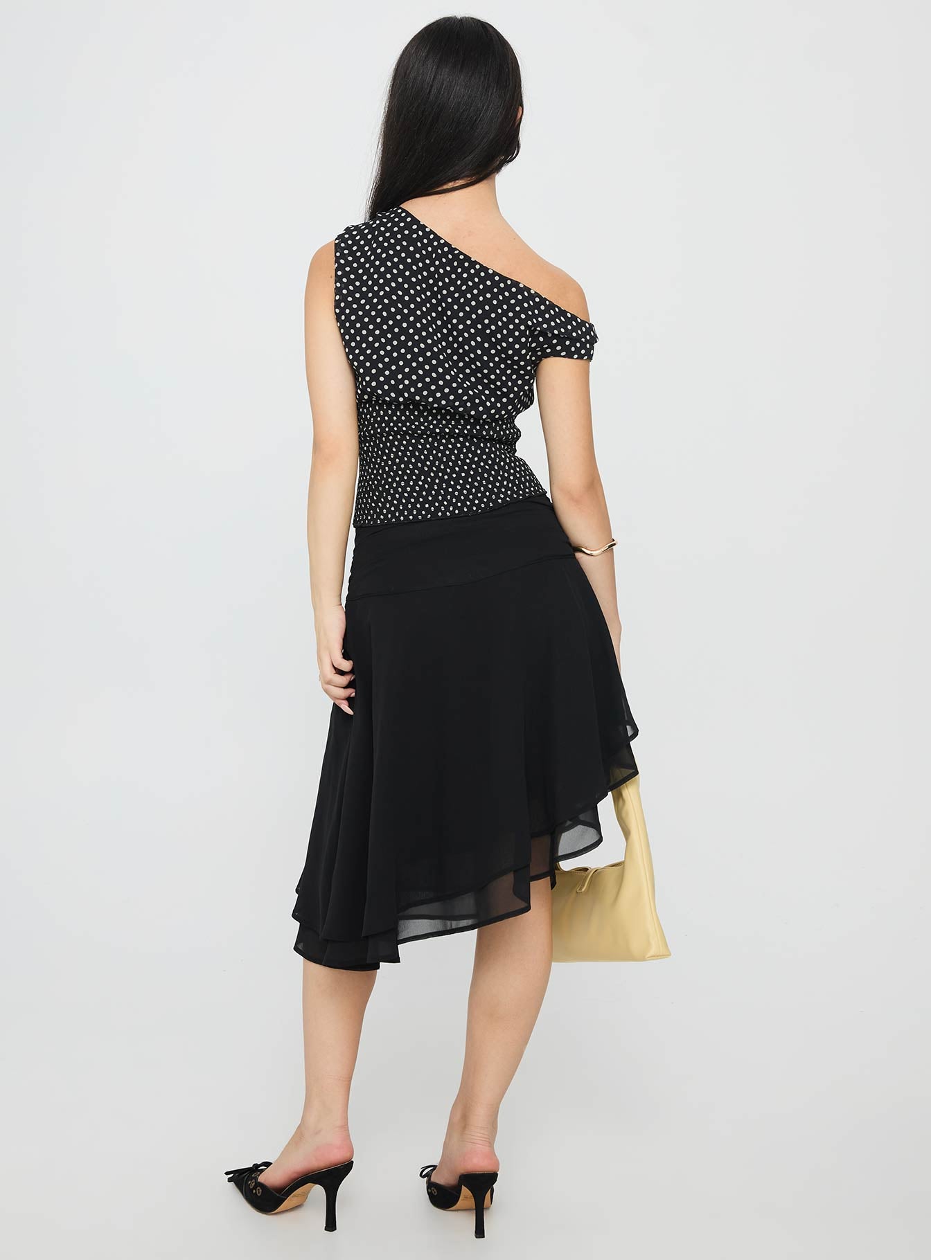 back view of model wearing Princess Polly Evanescence Asymmetrical Midi Skirt Black Midi Skirts