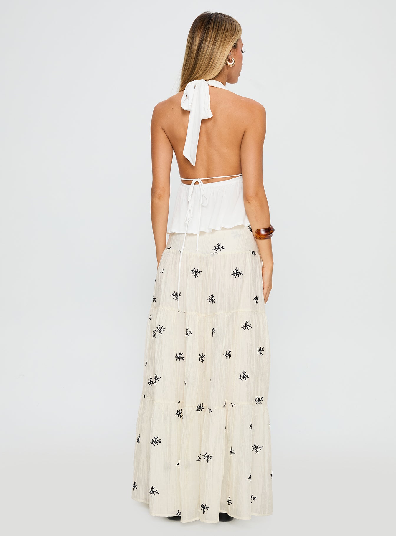 back view of model wearing Princess Polly Cinnamon Embroidered Maxi Skirt Cream / Navy Maxi 