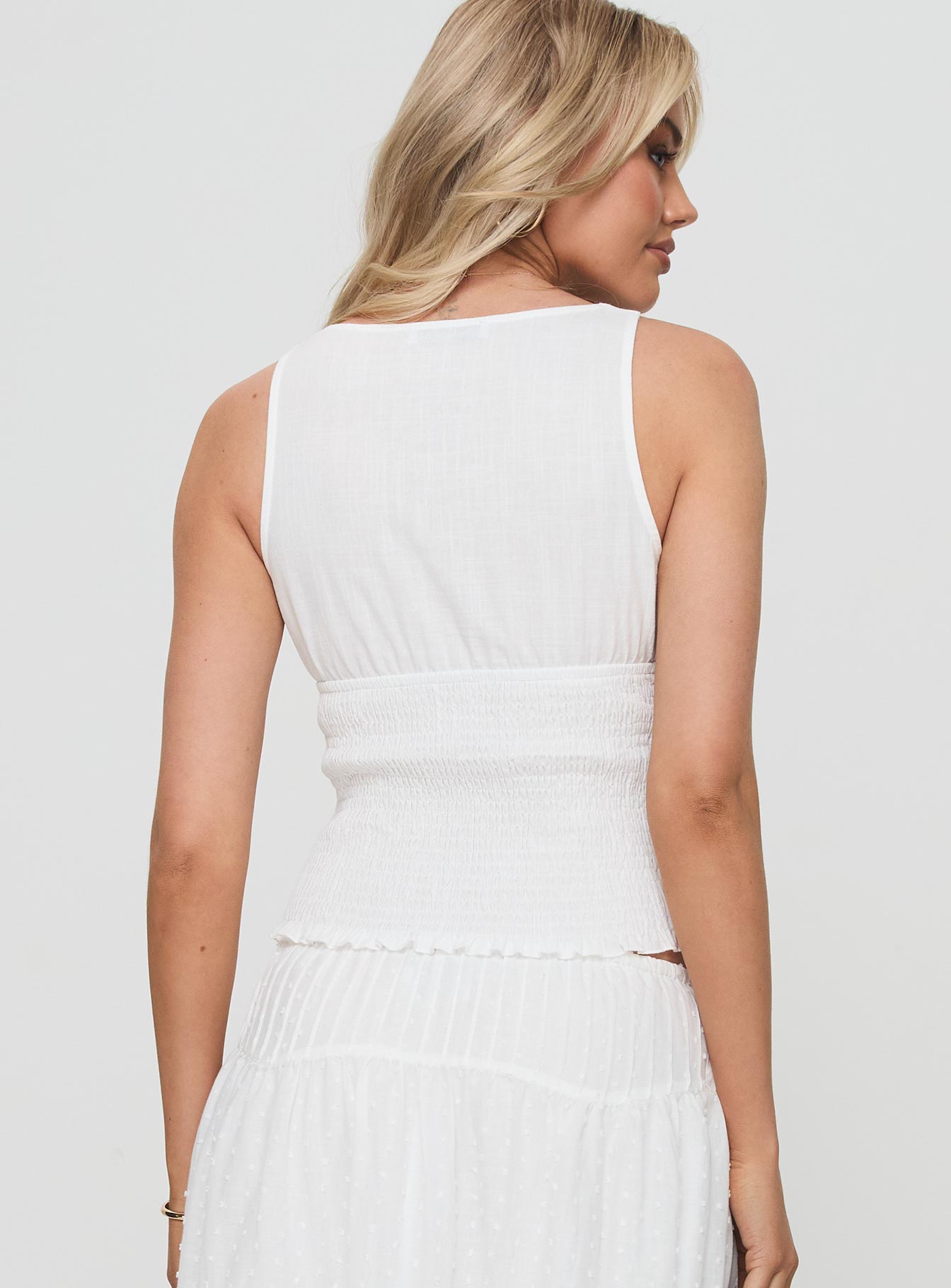 back view of model wearing Princess Polly Barletta Top White Sleeveless Plunger 