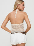 back view of model wearing Princess Polly Astona Lace Halter Cream Sleeveless Plunger 