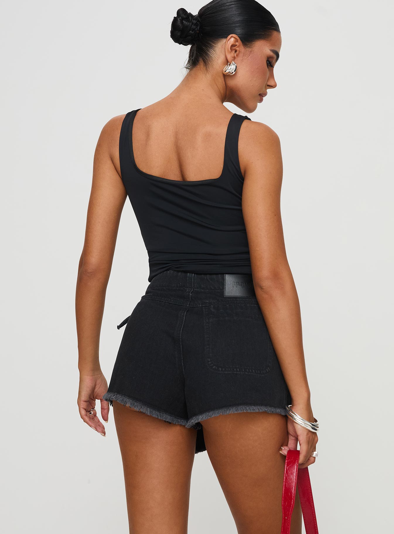 back view of model wearing Princess Polly Bowden Skort Washed Black High Waisted Shorts 