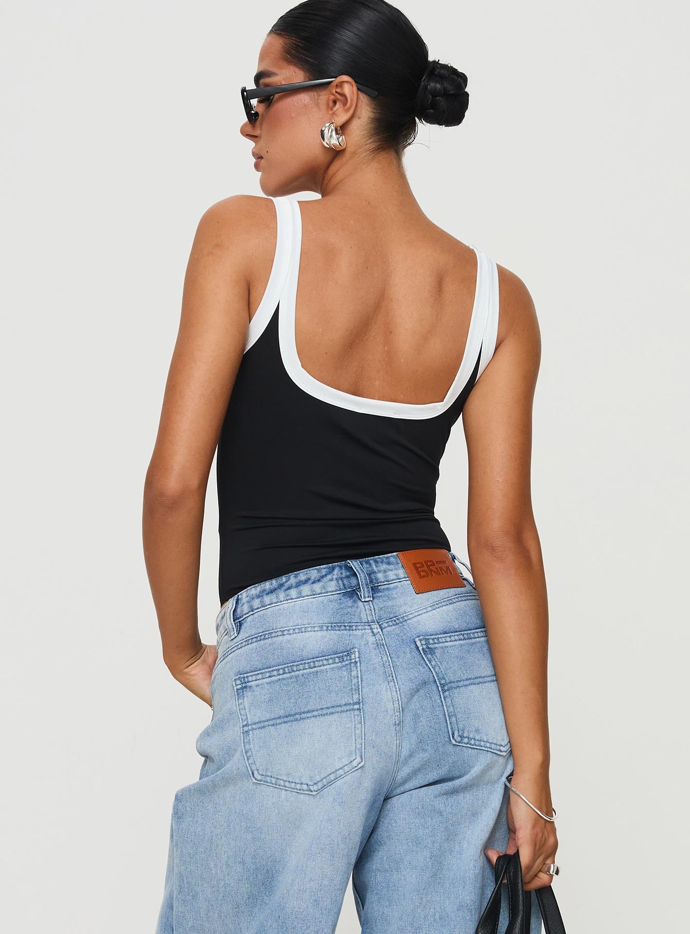 back view of model wearing Princess Polly Astrea Bodysuit Black / White Sleeveless 