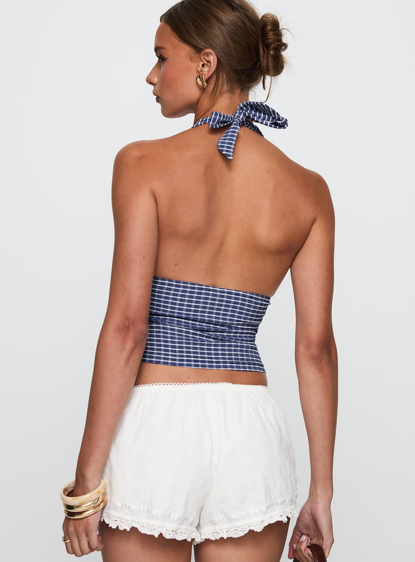 back view of model wearing Princess Polly Whimsy Halter Top Navy Gingham Sleeveless Sleeveless Plunger Plunger 