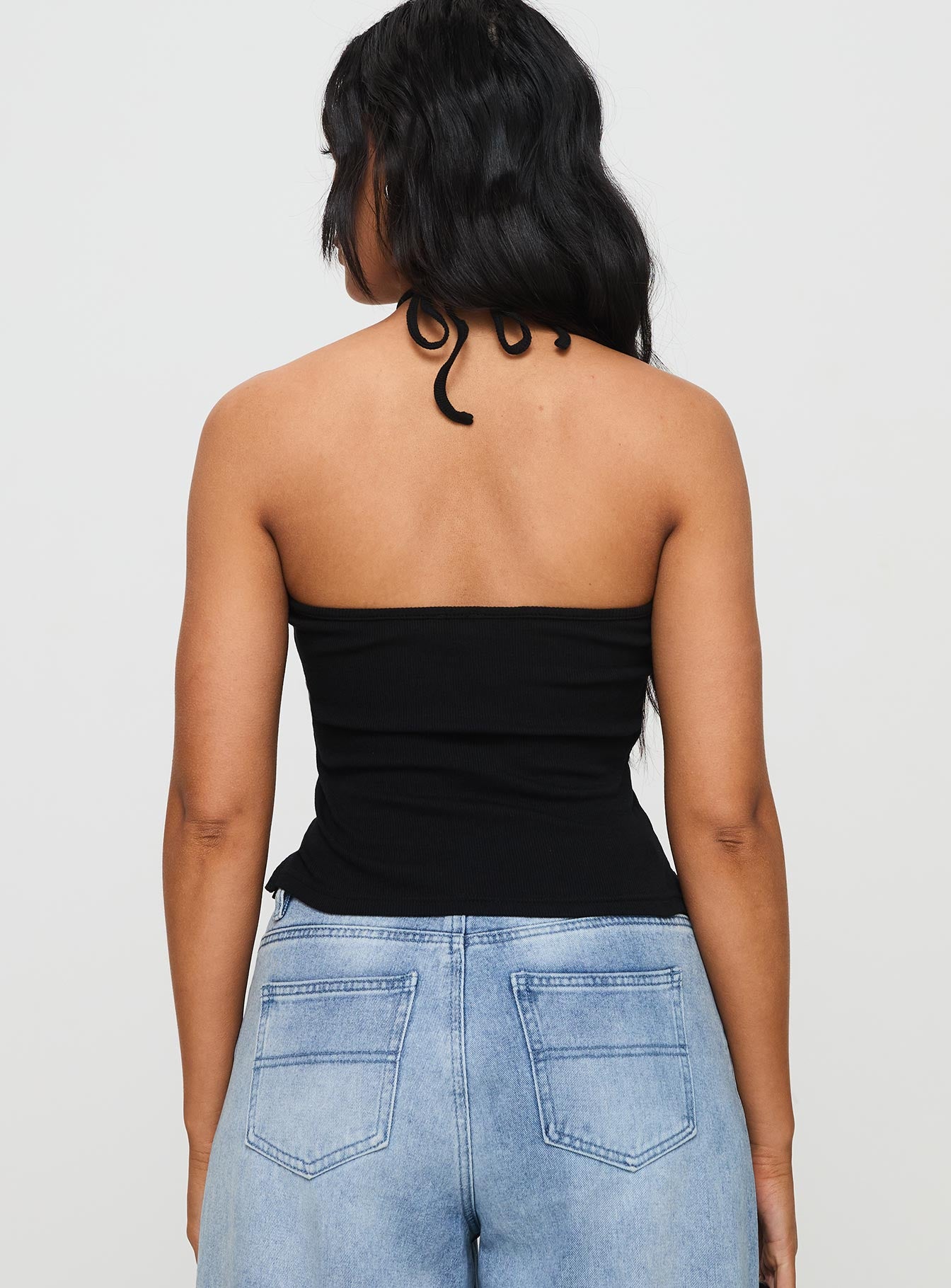 back view of model wearing Princess Polly Baseline Halter Rib Top Black Sleeveless 