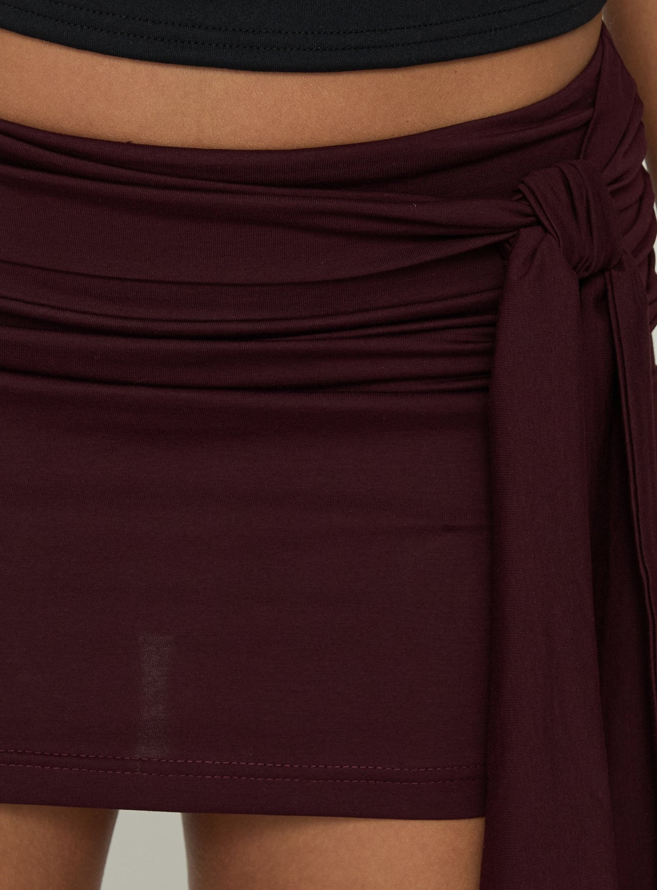 Designed with the Eldric Tie Waist Micro Skirt Aubergine womens-skirts in mini length detail view
