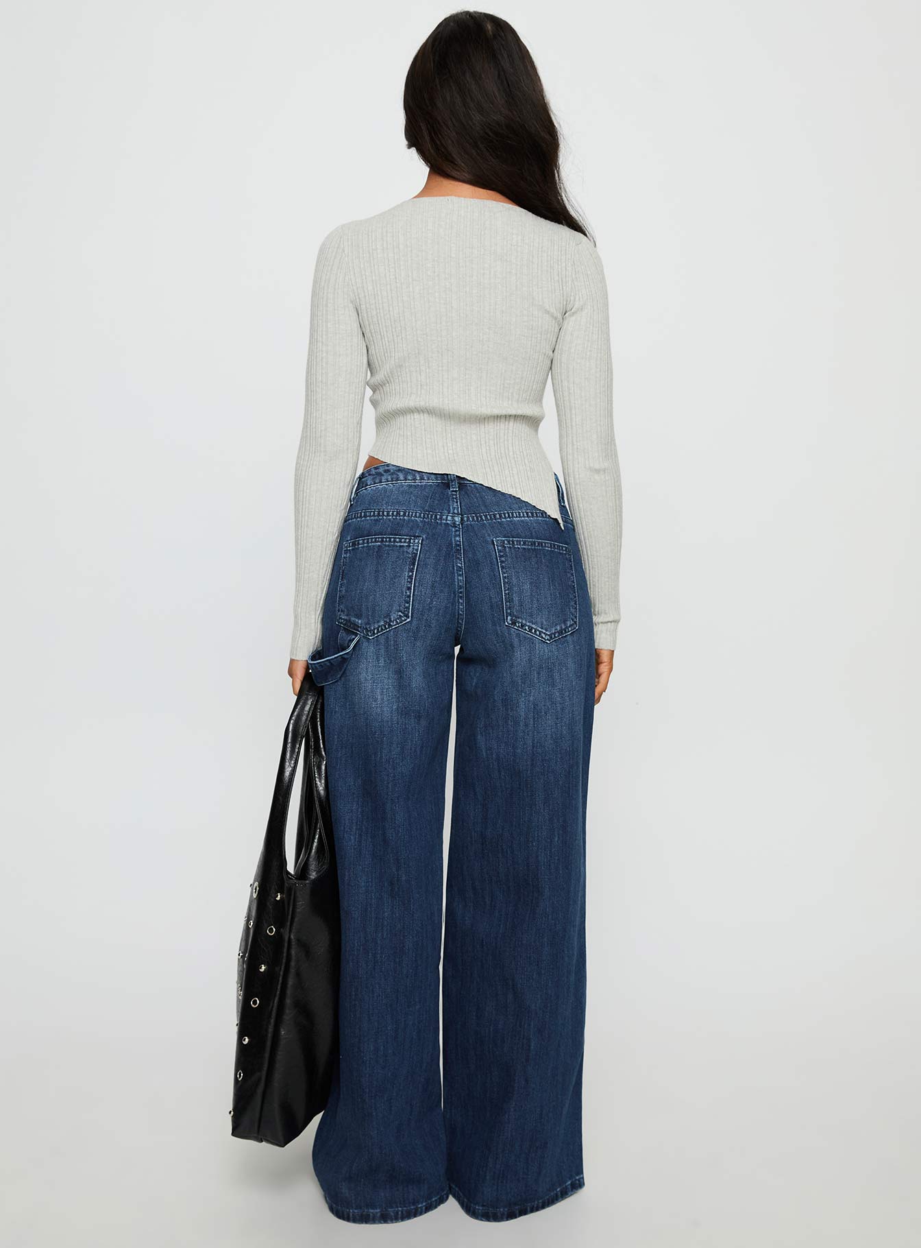 back view of model wearing Princess Polly Downtowner Low Rise Cargo Jeans Mid Blue Wash Low Rise Jeans 