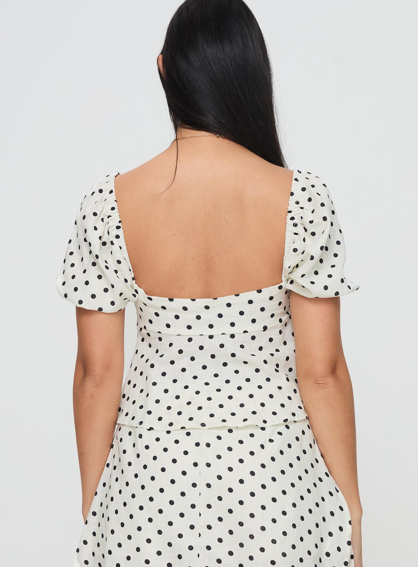 back view of model wearing Princess Polly Passionfruit Linen Blend Top Cream/Black Polka Dot Short Sleeves Square Neck 