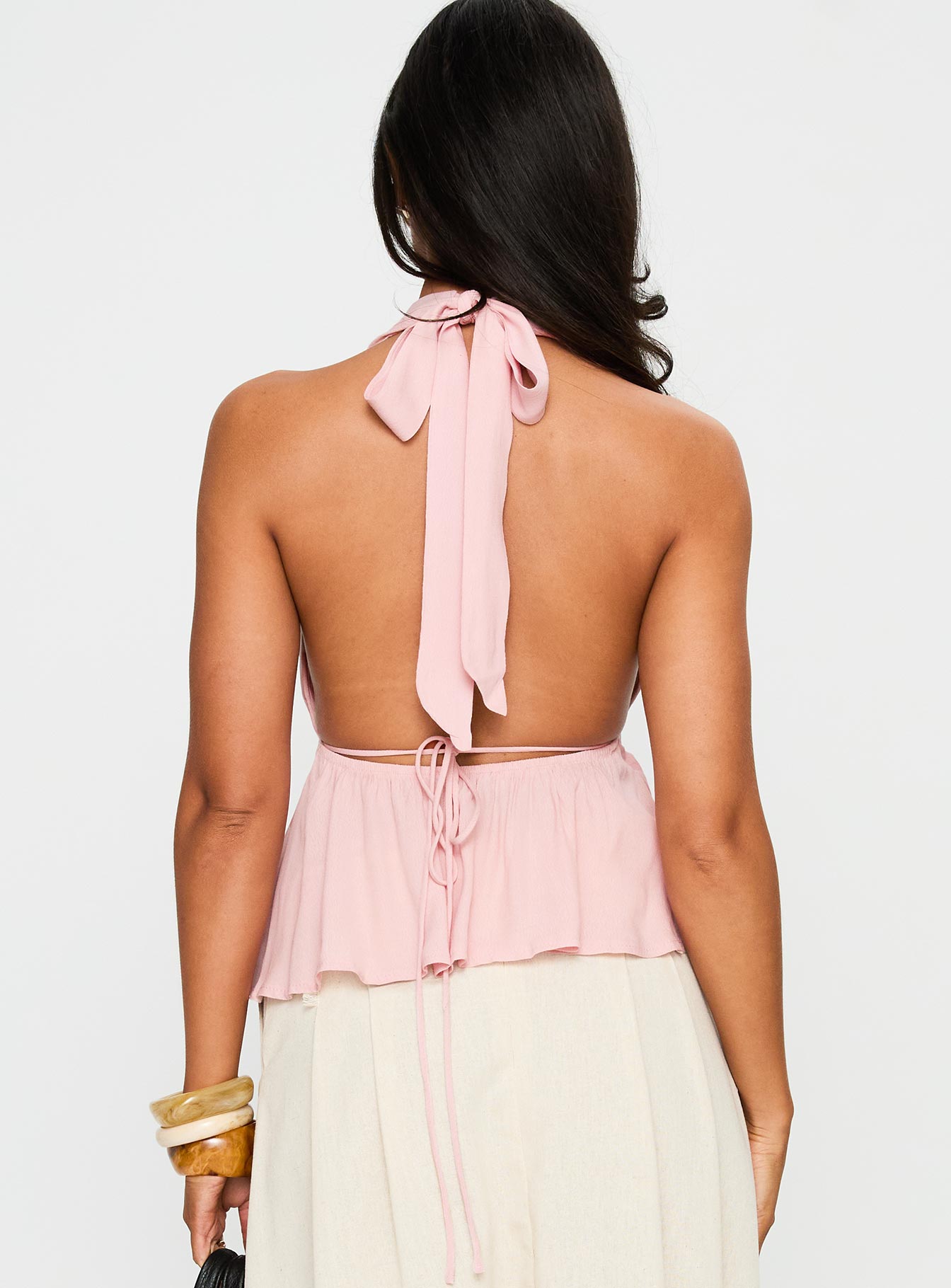 back view of model wearing Princess Polly Saddler Halter Top Pink Sleeveless Plunger 