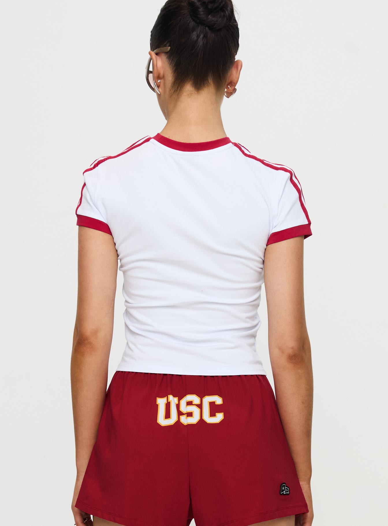 back view of model wearing Princess Polly USC Goalie Baby Tee White Short Sleeves Crew Neck 