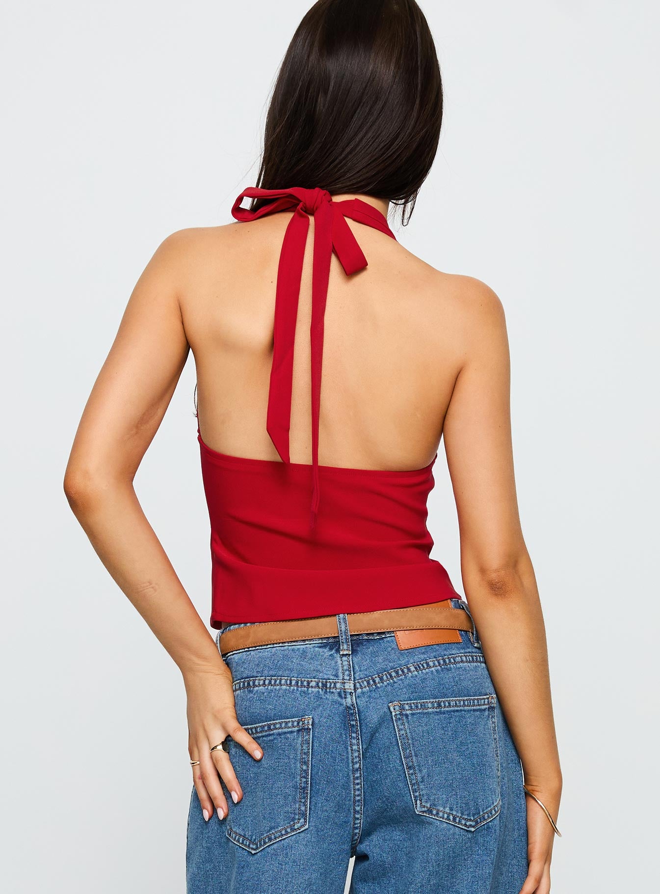 back view of model wearing Princess Polly Serefina Halter Top Red Sleeveless Plunger 