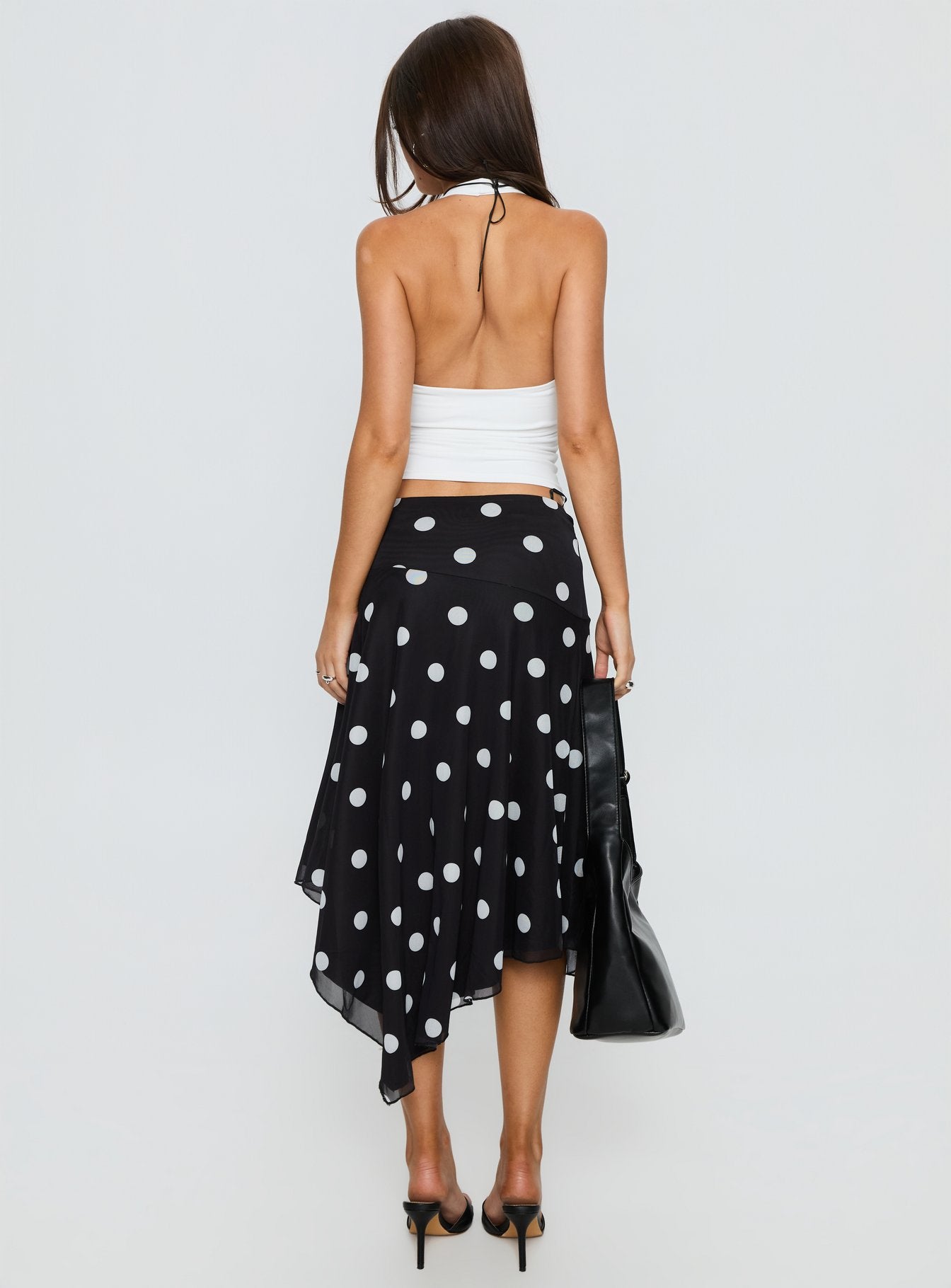 back view of model wearing Princess Polly Dulciana High Split Asymmetrical Midi Skirt Black / Polka Dot Midi Skirts 