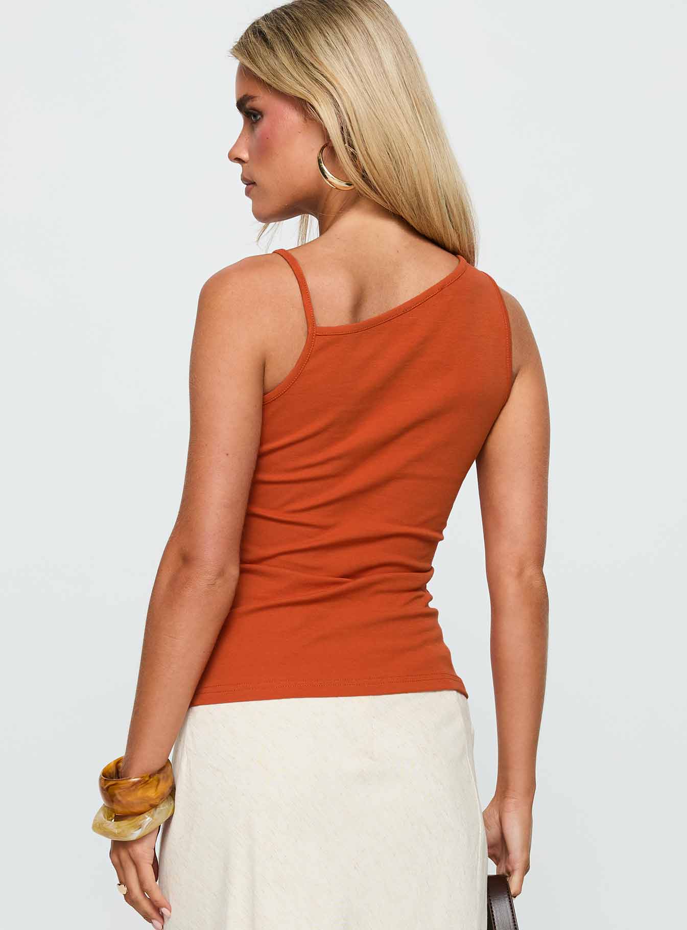 back view of model wearing Princess Polly Amarante Sleeveless Top Orange Sleeveless Asymmetric Neckline 