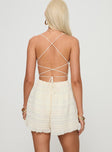 Romper V neckline, adjustable straps, open back with cross-over detail, tie fastening Non-stretch material, fully lined 