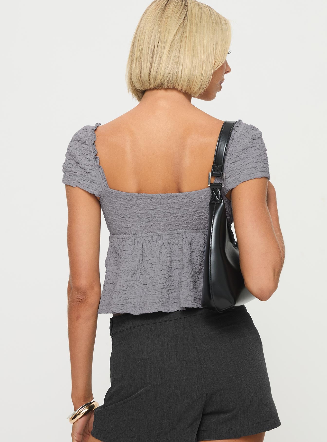 back view of model wearing Princess Polly Kellan Cap Sleeve Top Blue Short Sleeves Plunger 