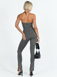 Strapless jumpsuit Inner silicone strip at bust Invisible zip fastening at back Split at cuff Slim leg Fully lined