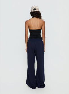 back view of model wearing Princess Polly Summits Flared Track Pants Navy Mid Rise Pants 
