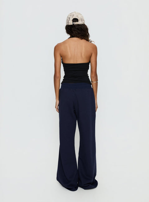 back view of model wearing Princess Polly Summits Flared Track Pants Navy Mid Rise Pants 