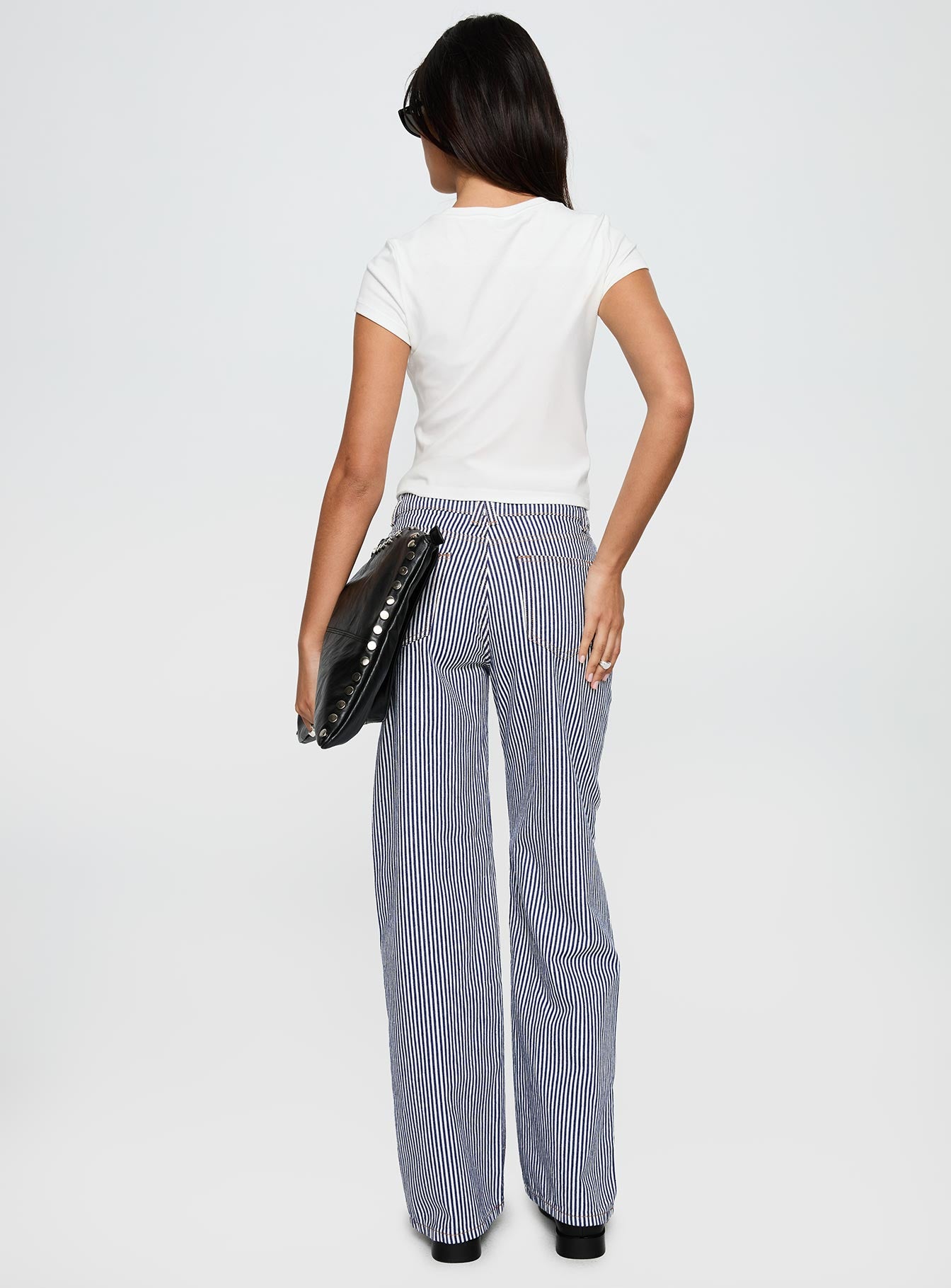 back view of model wearing Princess Polly Top Model Jean Navy Stripe Low Rise Pants 