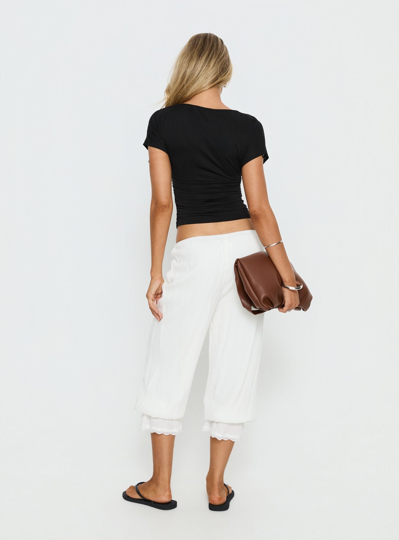 back view of model wearing Princess Polly Basma Bloomer Trouser Pants Rayon White Mid Rise Pants 
