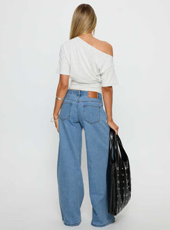 back view of model wearing Princess Polly Supercut Low Rise Baggy Pleat Jeans Light Blue Wash Low Rise Jeans 