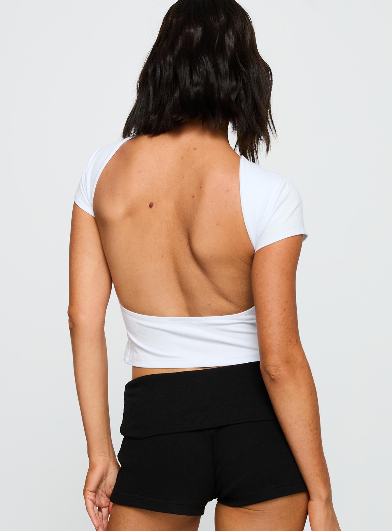 back view of model wearing Princess Polly Stanford Comeback Top White Short Sleeves Crew Neck 