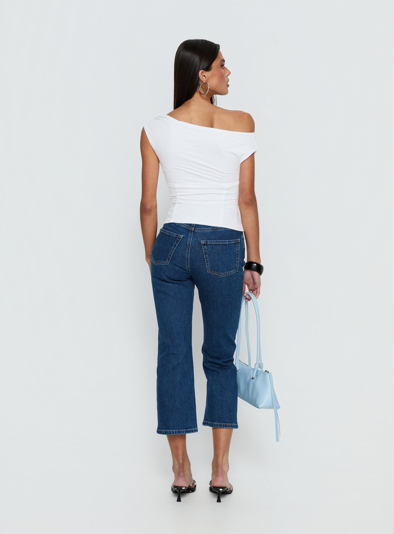 back view of model wearing Princess Polly Cindee High Rise Cropped Jeans Mid Blue Wash High Rise Jeans 
