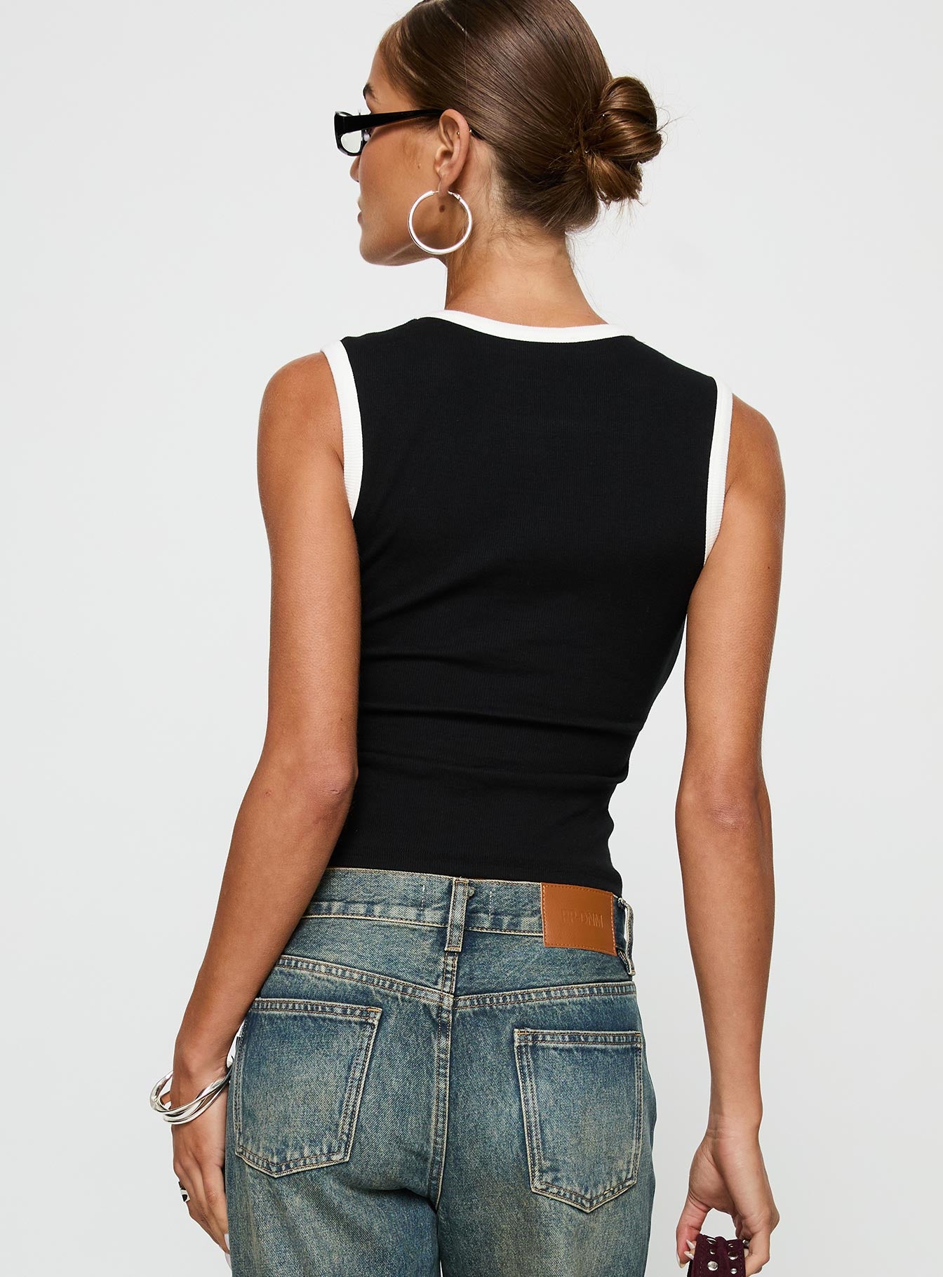 back view of model wearing Princess Polly Start Me Up Top Black / White Sleeveless Scoop Neck 