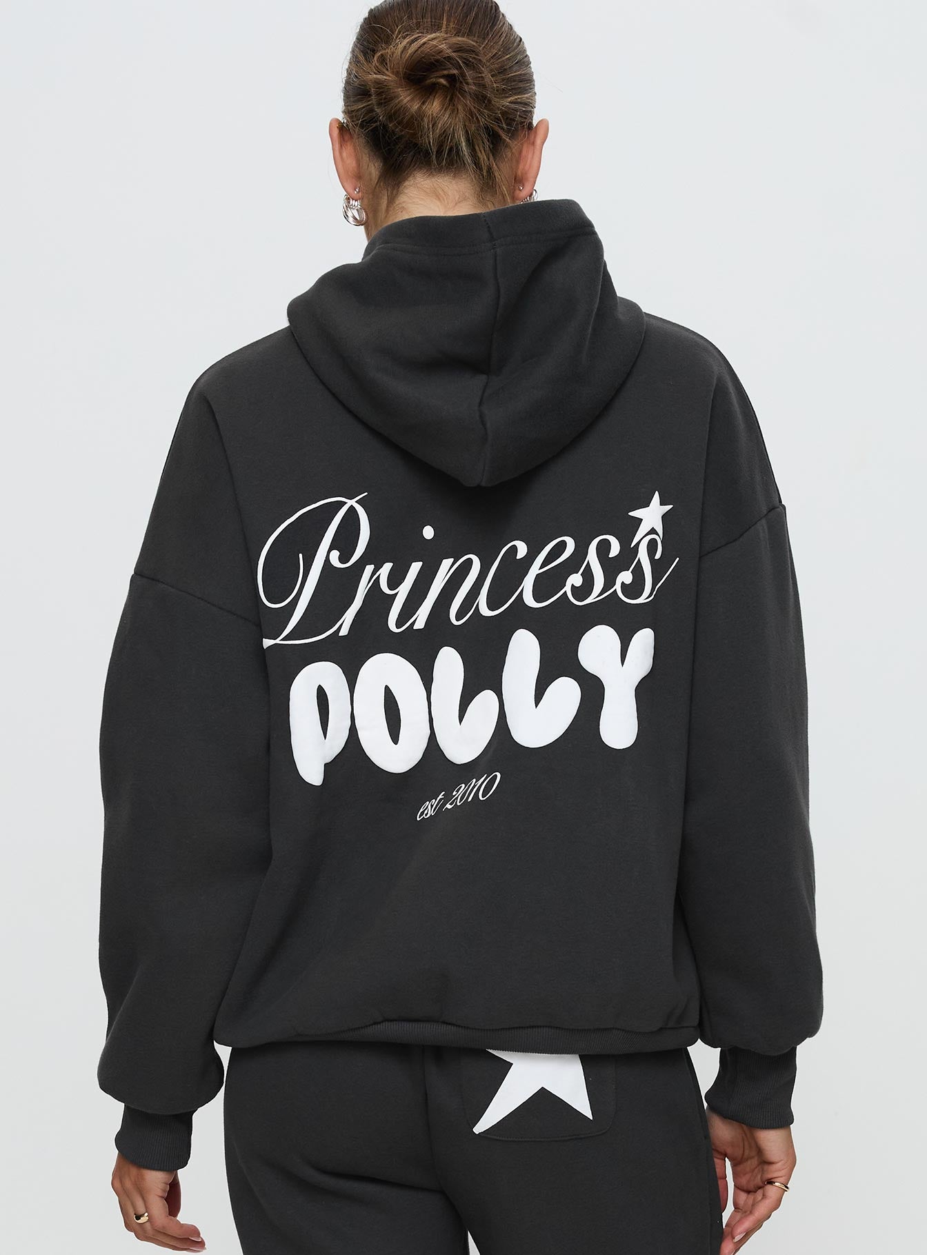 back view of model wearing Princess Polly Princess Polly Hooded Sweatshirt Bubble Script Grey 