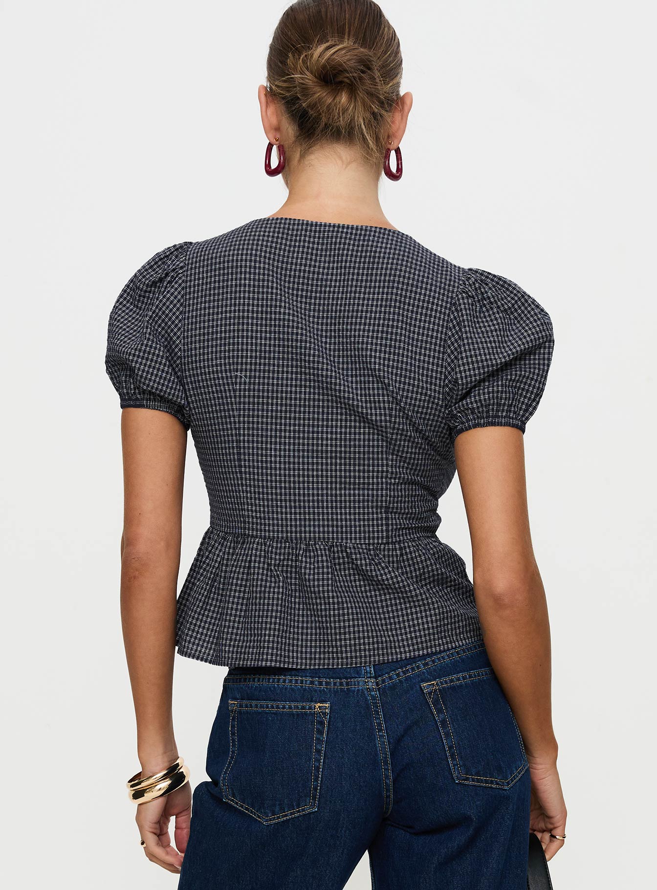 back view of model wearing Princess Polly Verah Tie Up Puff Sleeve Top Navy Check Short Sleeves Scoop Neck 