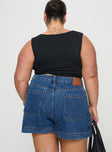 back view of model wearing Princess Polly Gazelle Denim Skort Mid Wash Curve High Waisted Shorts 