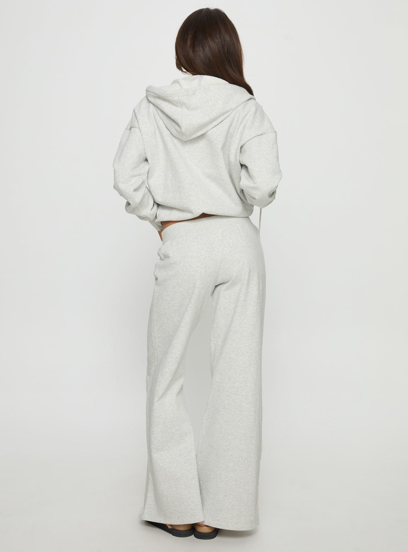 back view of model wearing Princess Polly Summits Flared Track Pants Grey Marle Mid Rise Pants 