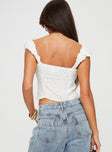 Floral top Fixed shoulder straps, button fastening at front, tie details along bust, pleated fabric under bust, lace trim
