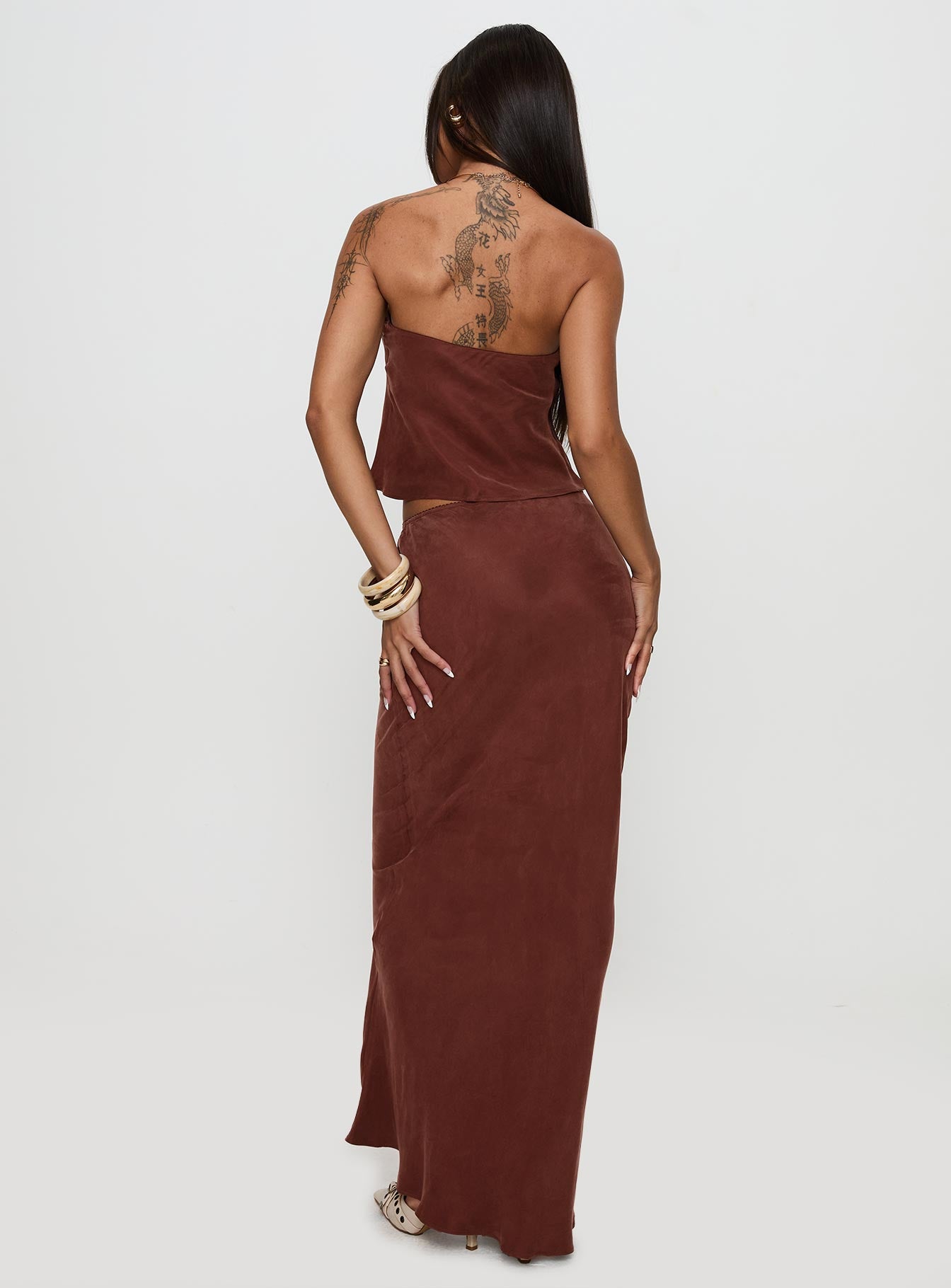 back view of model wearing Princess Polly Lucelia Maxi Skirt Brown Maxi 