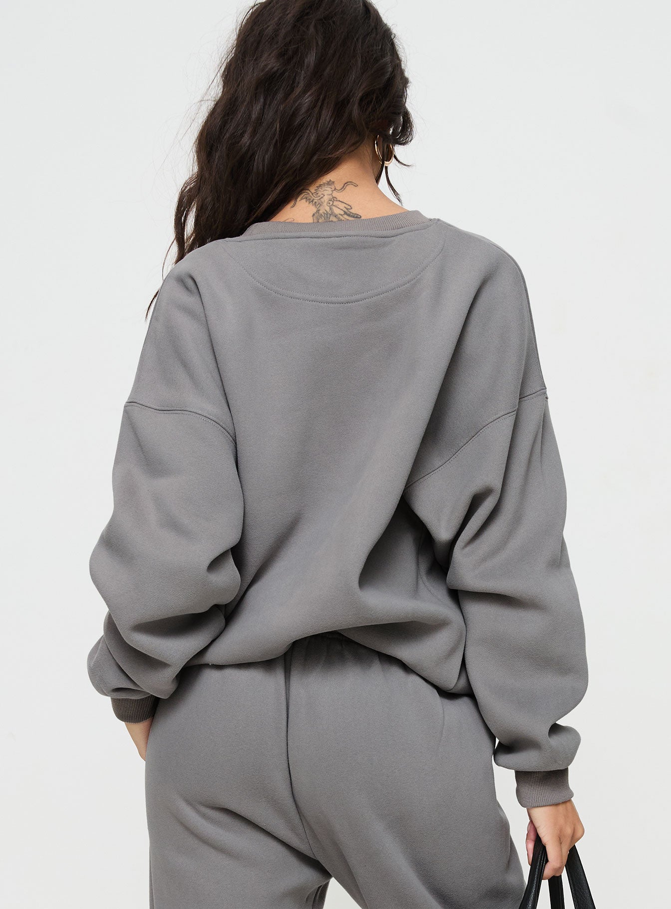 back view of model wearing Princess Polly Princess Polly Crew Neck Sweatshirt Puff Text Charcoal Long 