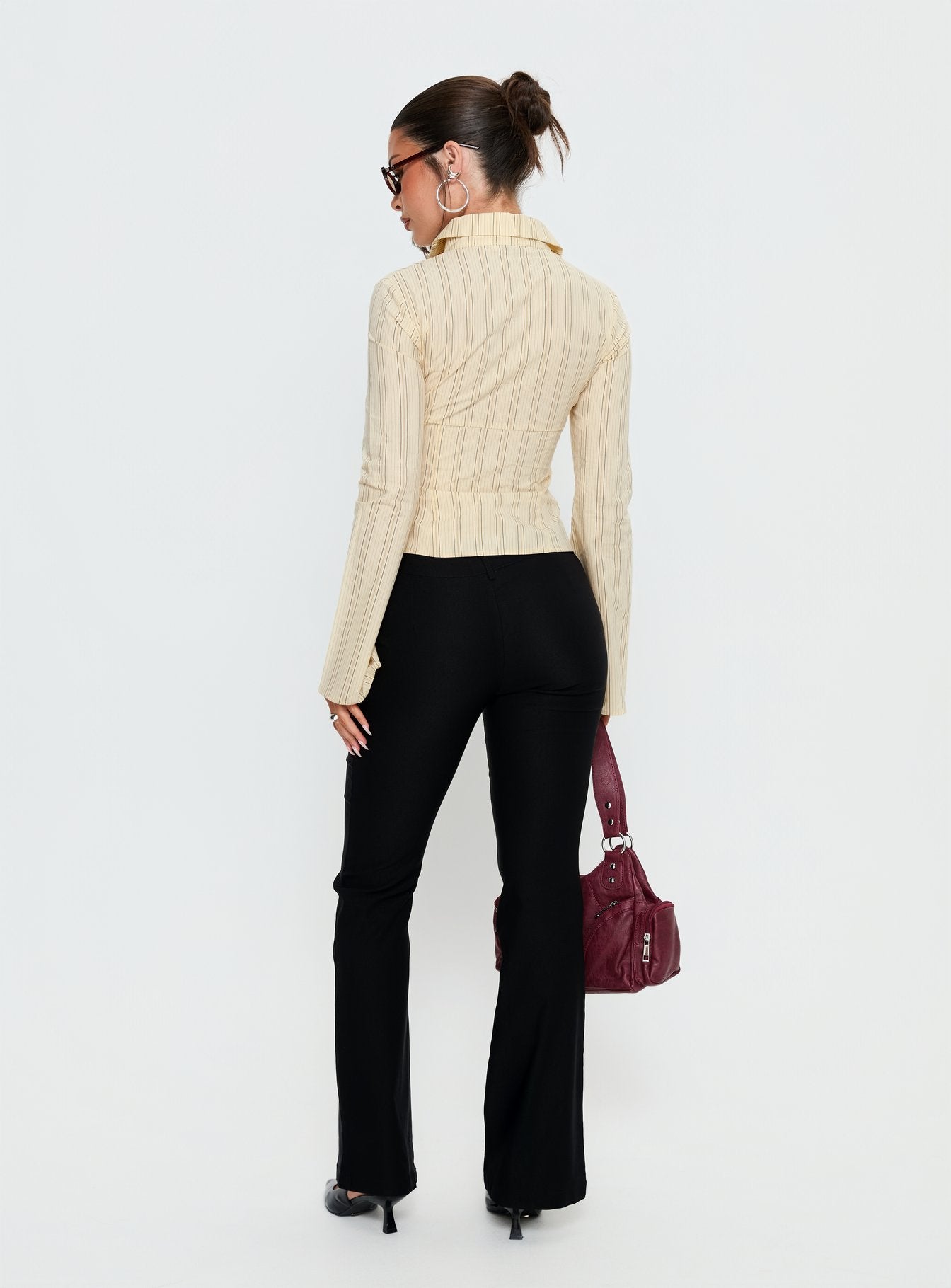 back view of model wearing Princess Polly Dariana Flare Pants Black Mid Rise Pants 