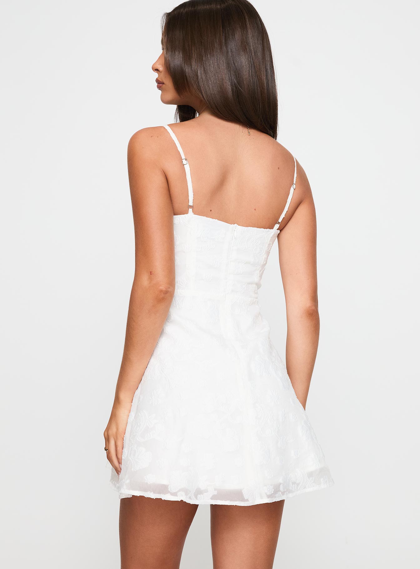 back view of model wearing Princess Polly New Chapters Broderie Mini Dress White Sweetheart Neckline 