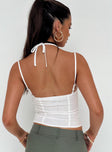 Crop top Adjustable shoulder straps Halter neck tie fastening Lace trim Ribbon detail at bust Invisible zip fastening at side