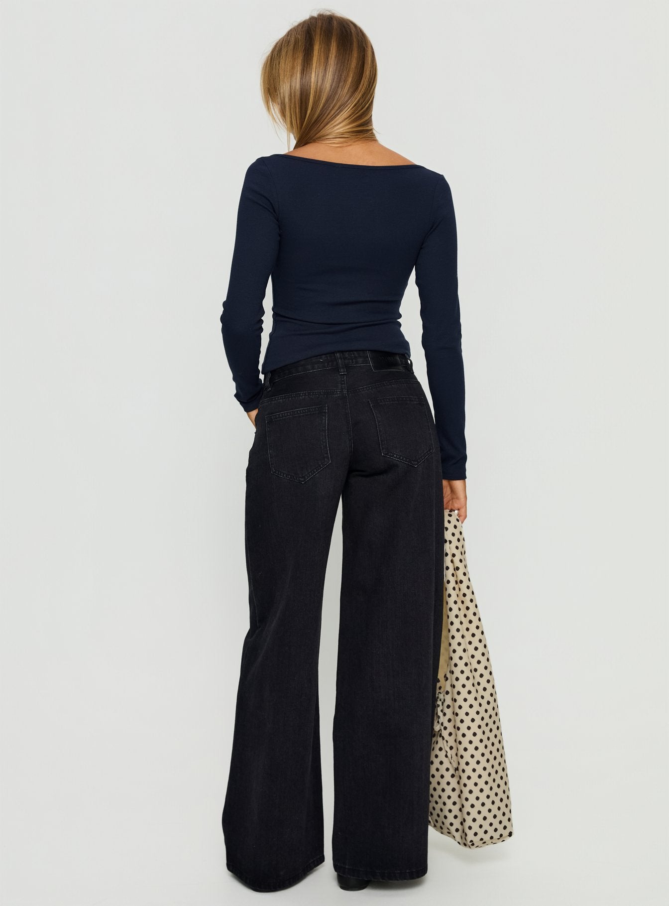 back view of model wearing Princess Polly Supercut Low Rise Baggy Pleat Jeans Washed Black Low Rise Jeans 