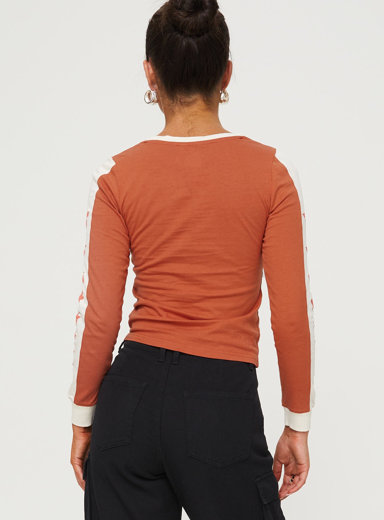 back view of model wearing Princess Polly 99 Roa Long Sleeve Top Orange Full Sleeves Crew Neck 