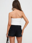 back view of model wearing Princess Polly Symphony Denim Skort Washed Black High Waisted Shorts 