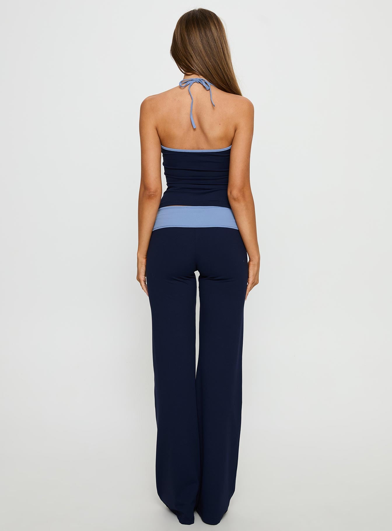 back view of model wearing Princess Polly Kobee Jersey Flare Pants Navy / Light Blue High Rise Pants 