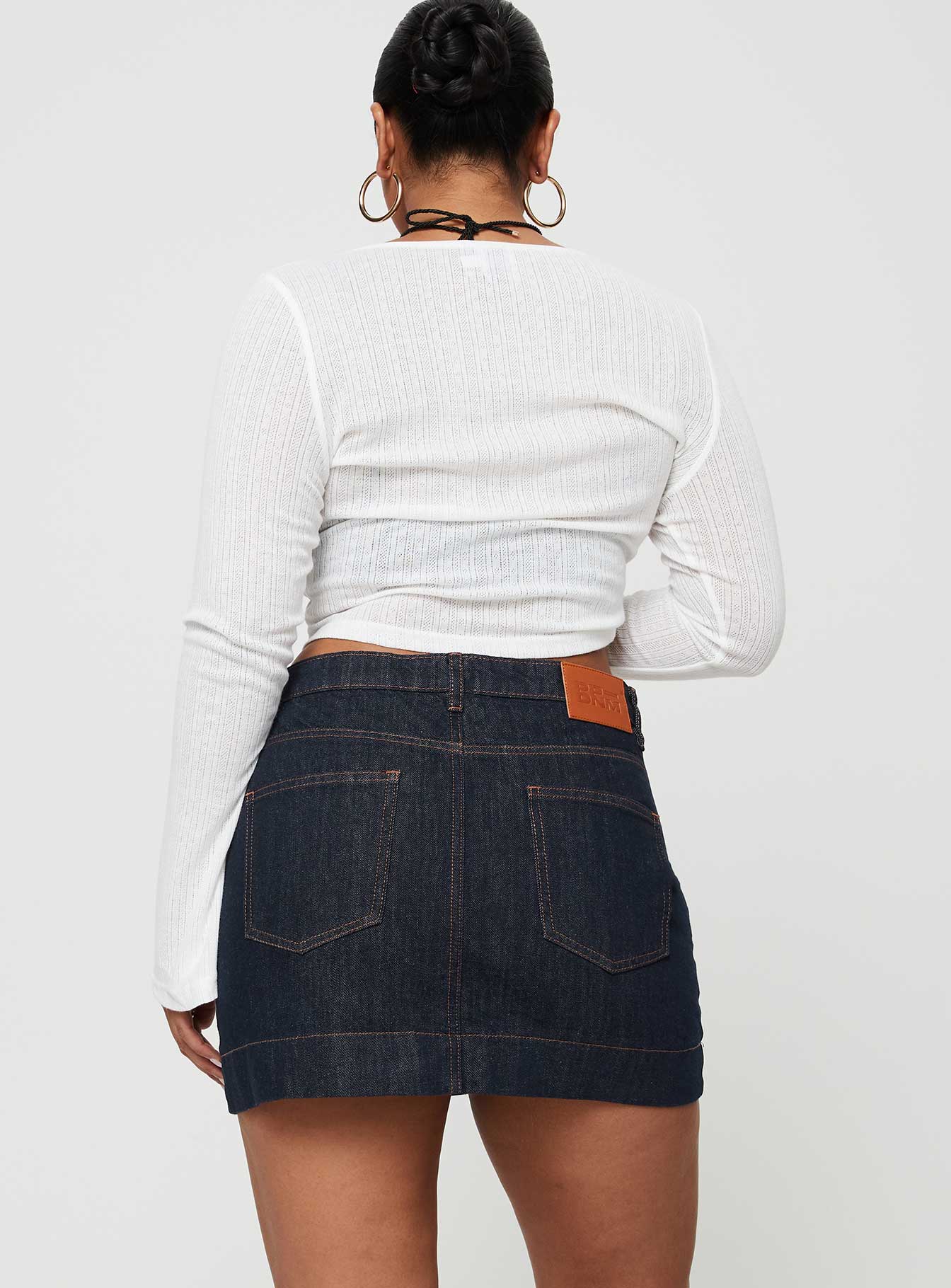 back view of model wearing Princess Polly Hughes Mini Skirt Dark Wash Denim Petite Mini Skirts 
