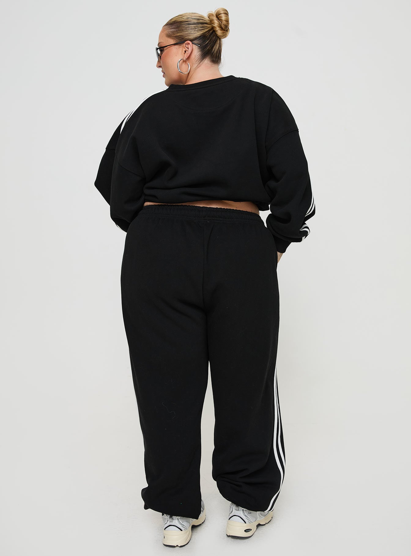 back view of model wearing Princess Polly Princess Polly Track Pants Stripe Black / White Curve High Waisted Pants 