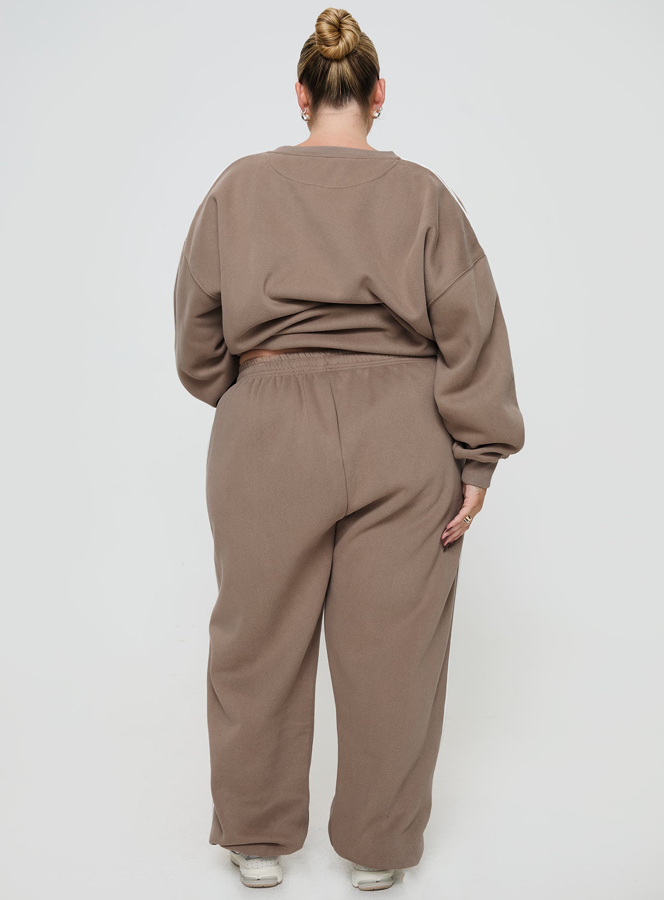 back view of model wearing Princess Polly Princess Polly Track Pants Stripe Taupe / White Curve 
