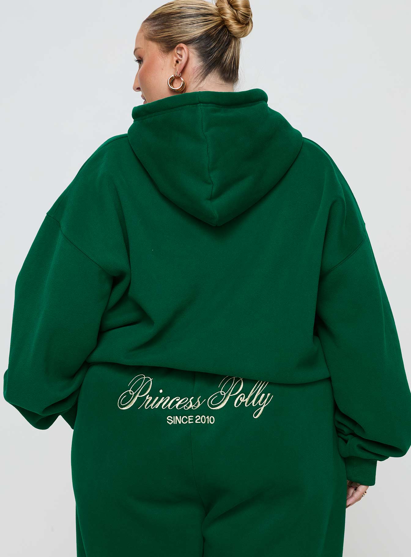 back view of model wearing Princess Polly Princess Polly Hooded Sweatshirt Script Green / Ivory Curve 